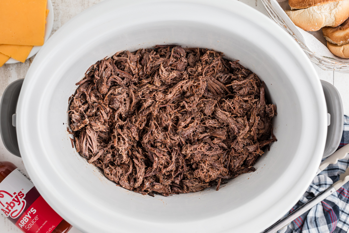 overhead of cooked meat for slow cooker arby's beef and cheddars.