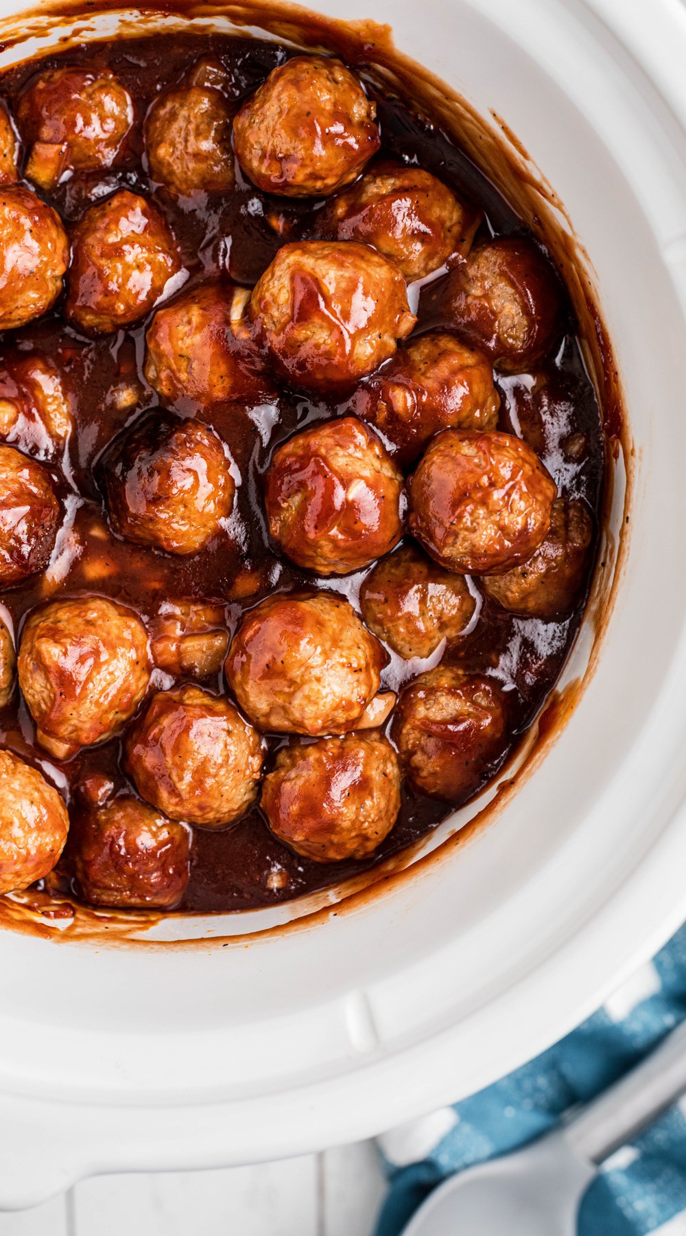 long image of bbq meatballs in a slow cooker.