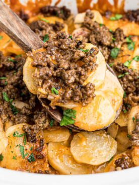 close up of beef and potatoes on a spatula.