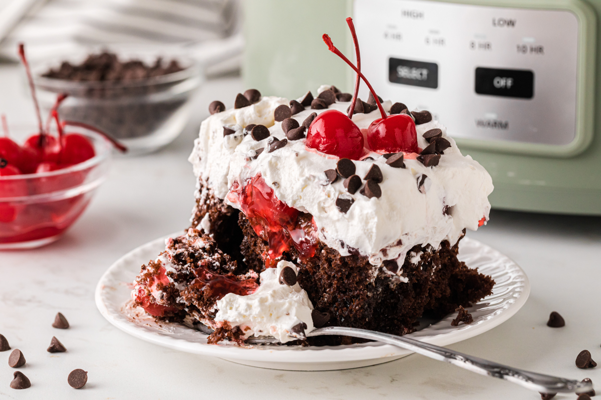 A piece of cake with a fork in front of it with some cake on it.