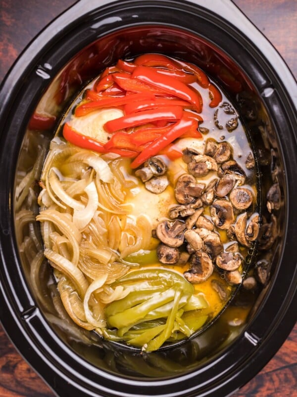 image of chicken, bell peppers, onions and mushrooms in slow cooker