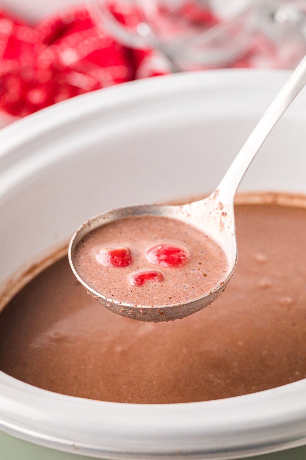 chocolate and cherries on a spoon.