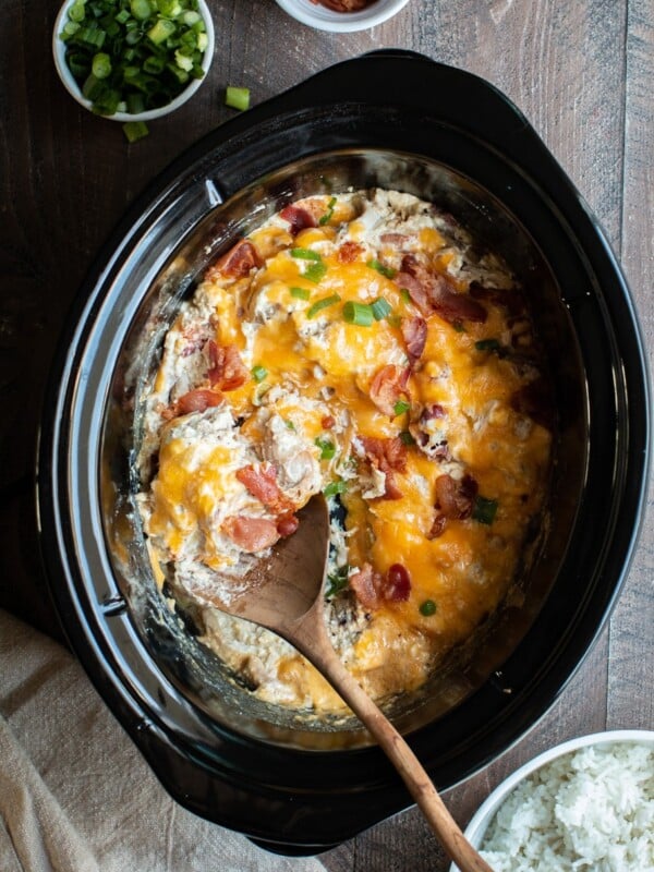 shredded creamy chicken with bacon and cheese on top.