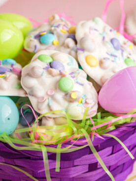 Basket filled with peanut clusters and plastic easter eggs.