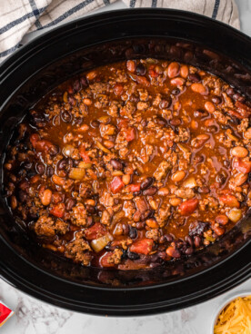 overhead shot of frito pie cooking in a crockpot.