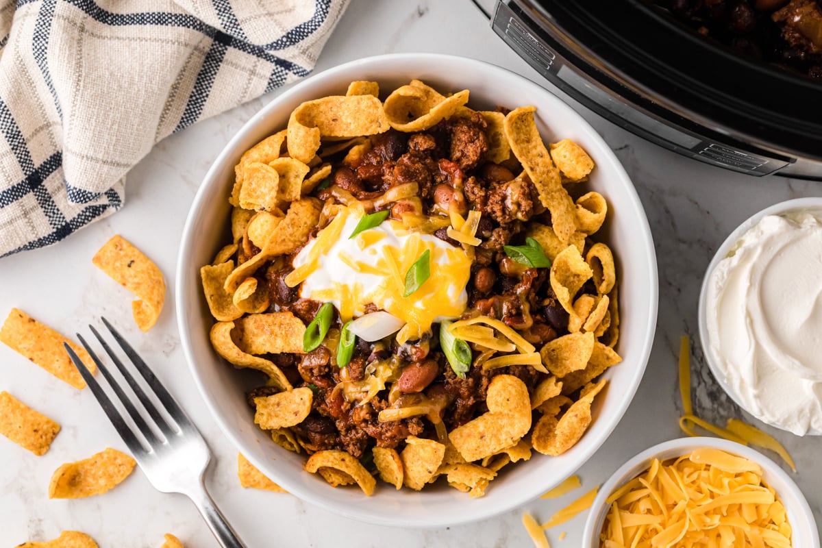 overhead shot of slow cooker frito pie in a bowl.