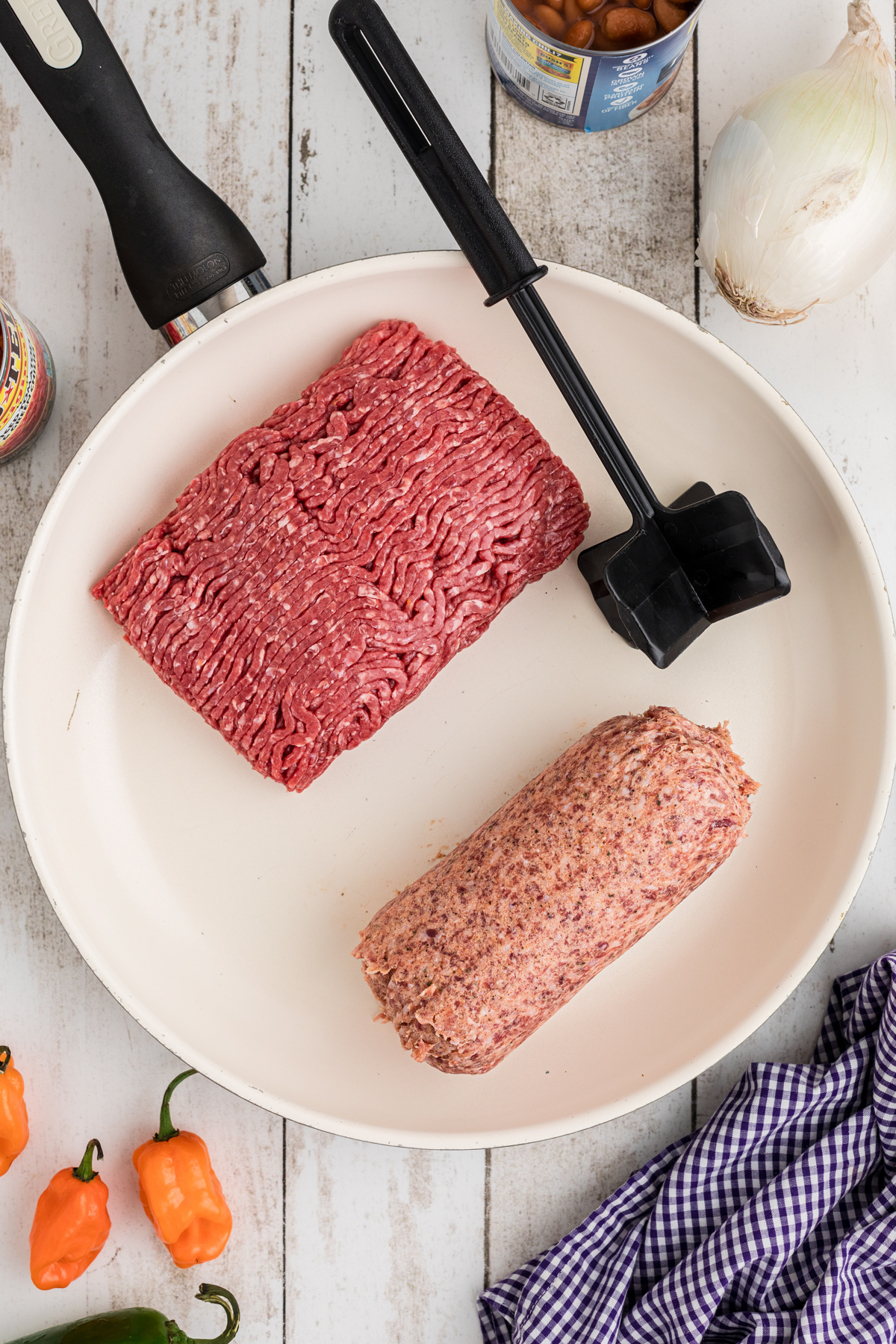 Ground beef and pork sausage in a skillet.