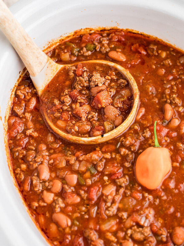 Slow cooker habanero chili with a ladle scooping some out.