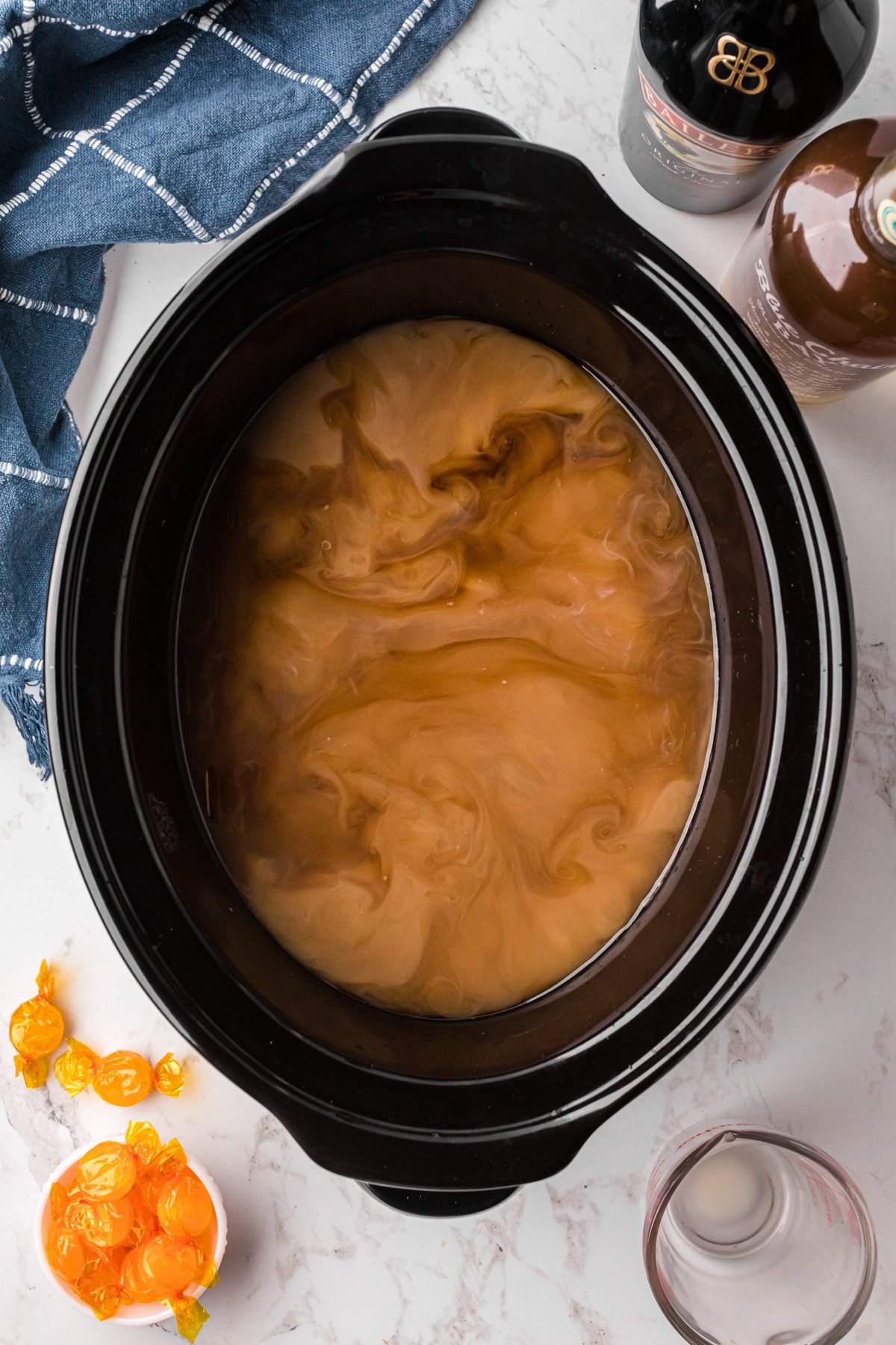 Buttershots, vanilla rum, and Baileys Irish cream added to coffee in a slow cooker.