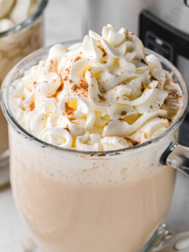 slow cooker hot white russians with whipped cream in glass mugs.