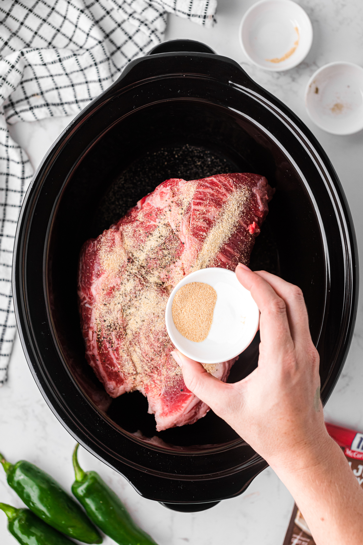 Seasoning beef in a slow cooker.