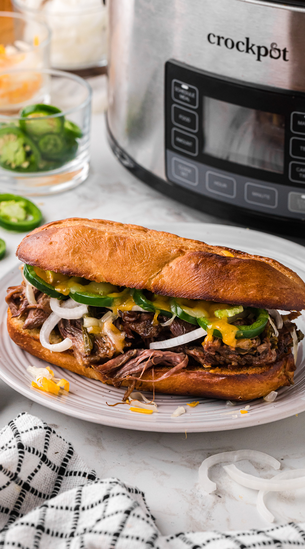 Long image of one of the slow cooker jalapeno beef sammies.