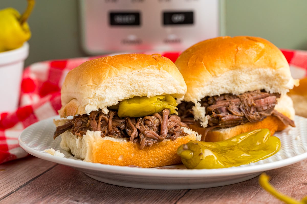 slow cooker Mississippi pot roast on slider rolls on a plate.