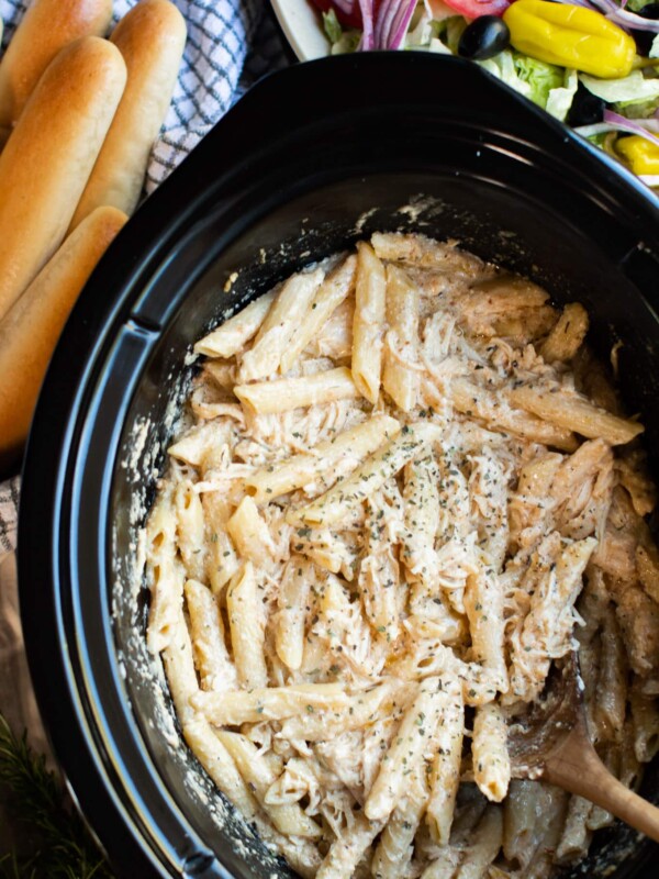 close up of pasta, chicken and cheese in slow cooker