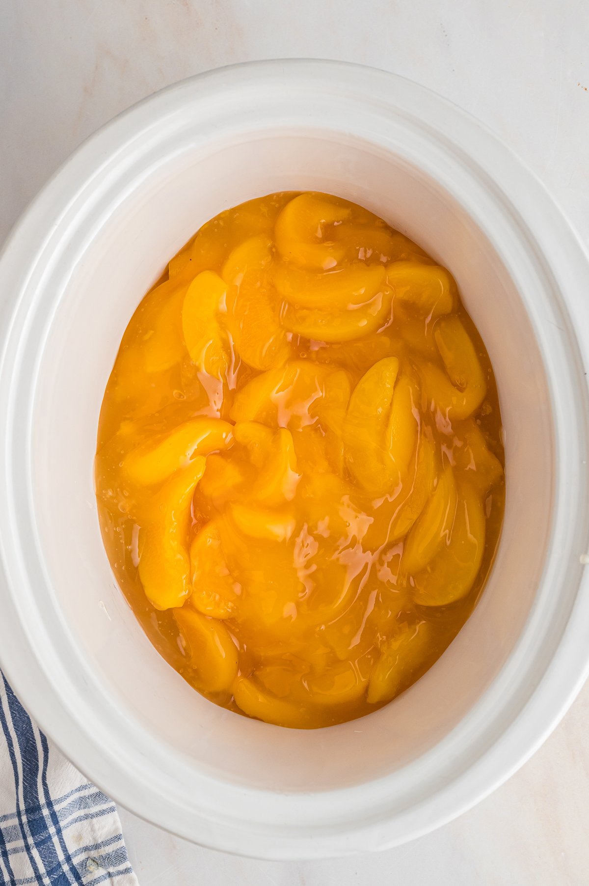 CANNED PEACHES ON THE BOTTOM OF A SLOW COOKER.