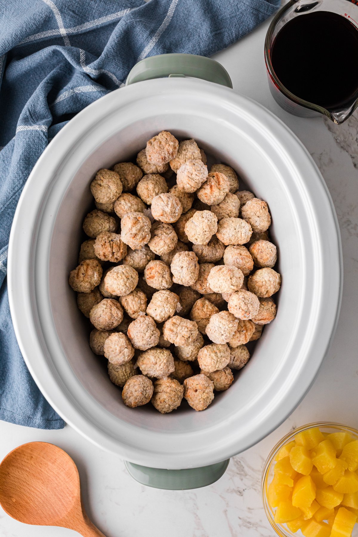 Frozen meatballs in a slow cooker.