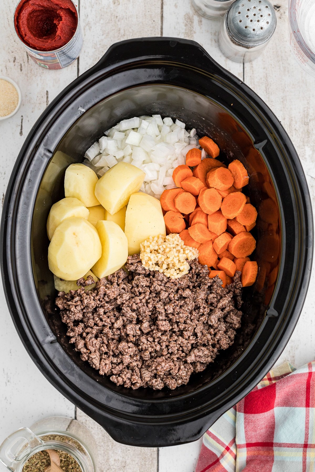 Vegetables and ground beef in a crockpot.