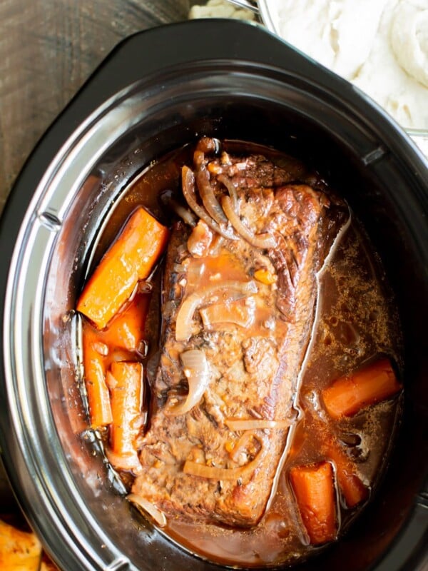 close up of cooked brisket with carrots.