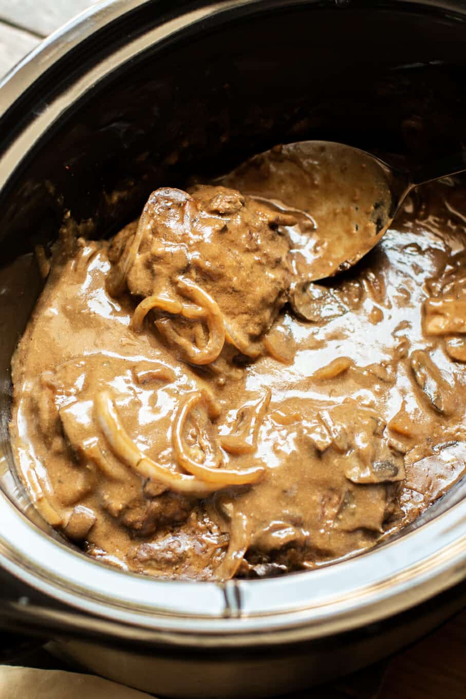 cooked salisbury steaks in gravy in slow cooker