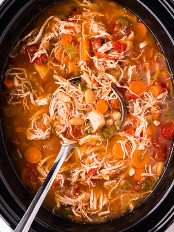 close up of tuscan white bean soup in the slow cooker.